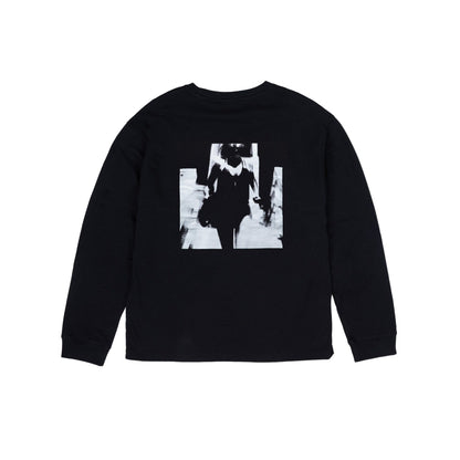 Black long-sleeve shirt with a graphic design on a light gray background