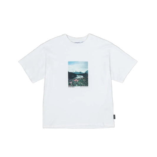 White t-shirt with a small graphic on a gray background