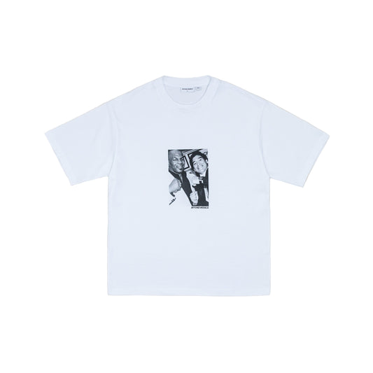 White t-shirt with black graphic on a light gray background