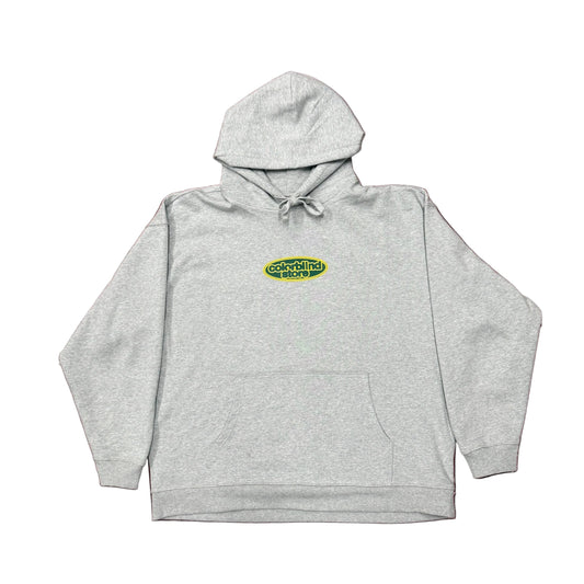 Gray hoodie with a logo on a green patterned background