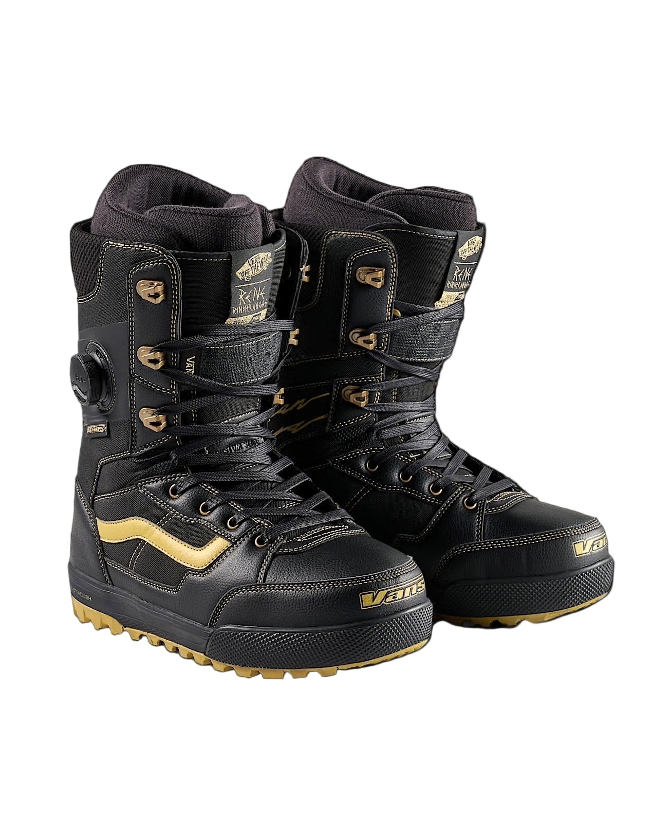 Black and gold snowboard boots on a black background