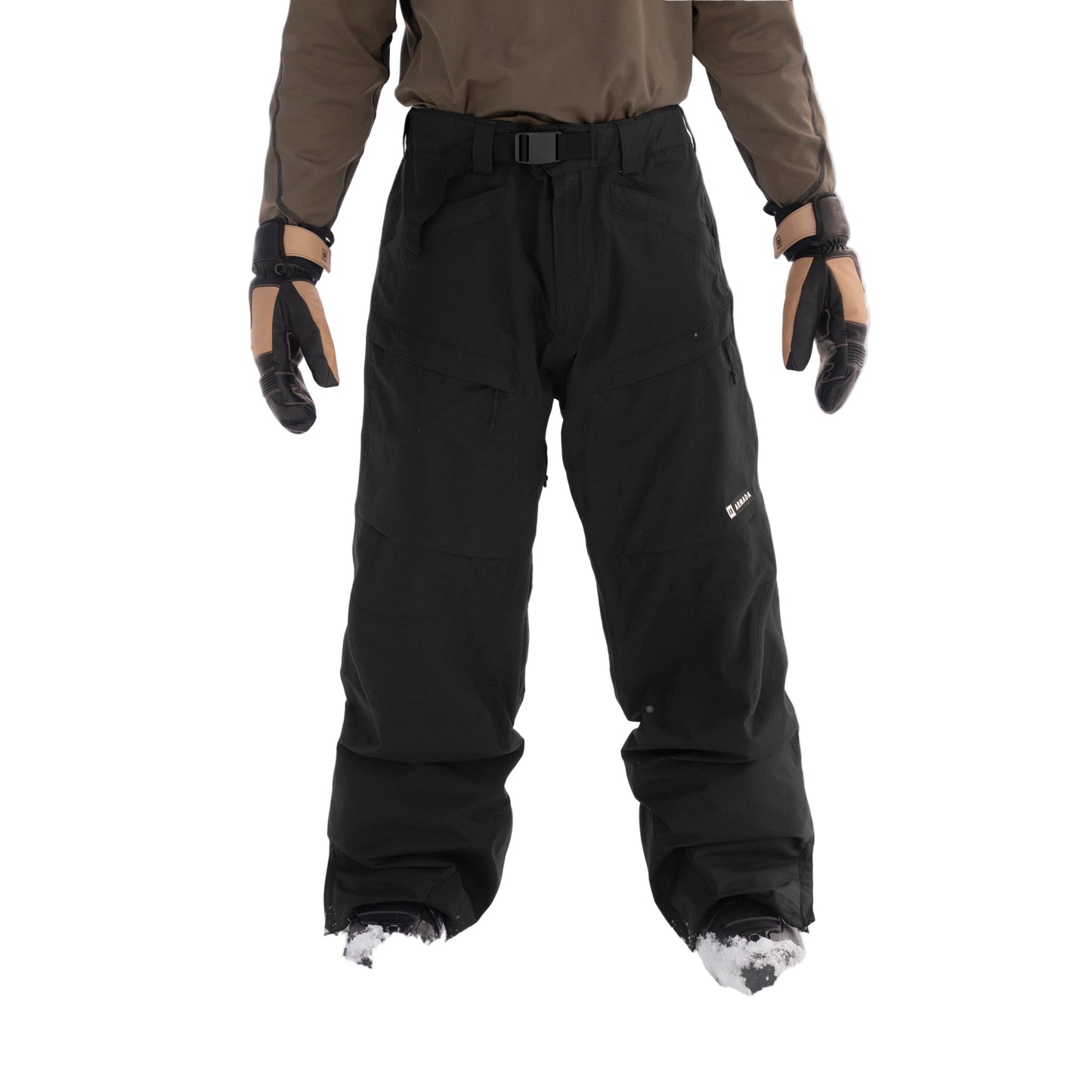 Person wearing black snow pants and brown jacket in a snowy landscape