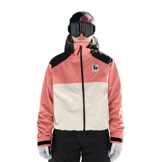 Person wearing a pink and beige jacket with black accents on a snowy background