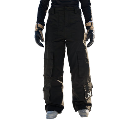 Person wearing black snow pants standing in a snowy landscape